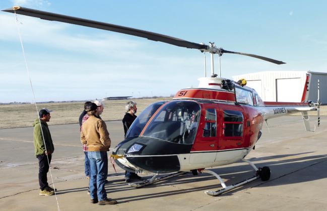 Pictured right, students and instructors of the Gordon Cooper Technology Center Aviation program check out the recently purchased Bell TH-57 helicopter. Photo provided by GCTC