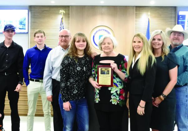 County commissioners from right, Greg Rush, Abby Thompson, and Melissa Dennis presented a plaque to the family of David Hammer. From left Garrett and Connor Hammer, Ronny Jones, Samantha Hammer and Ann Jones. The Pottawatomie Bar Association is having a plaque made to be placed at a tree in the courtyard of the Administration Building in honor of David Hammer. Countywide &amp;amp; Sun/Suzie Campbell