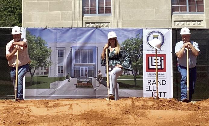 On Aug. 24, 2021, the Pottawatomie Board of County Commissioners broke ground for the new Pottawatomie Administration Building. Pictured above are two former commissioners (Eddie Stackhouse on the left and Randy Thomas on the right) and Commissioner Melissa Dennis. Between Dennis and Thomas is the hard hat and shovel in honor of Tommy Arnold who took on the task of getting everything ready for this day but passed before he could see the work begin or the vision completed. File photo.