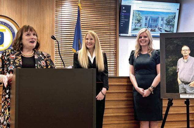 Gayla Arnold (pictured left) shares some little known stories about her late husband Tommy during the dedication ceremony. Commissioners Melissa Dennis and Abby Thompson get a chuckle out of some of the stories. Countywide &amp;amp; Sun/Suzie Campbell