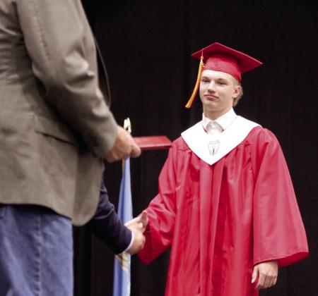 Ethan Andonian shakes hands as he looks ahead to his diploma. Natasha Dunagan, Countywide &amp;amp; Sun