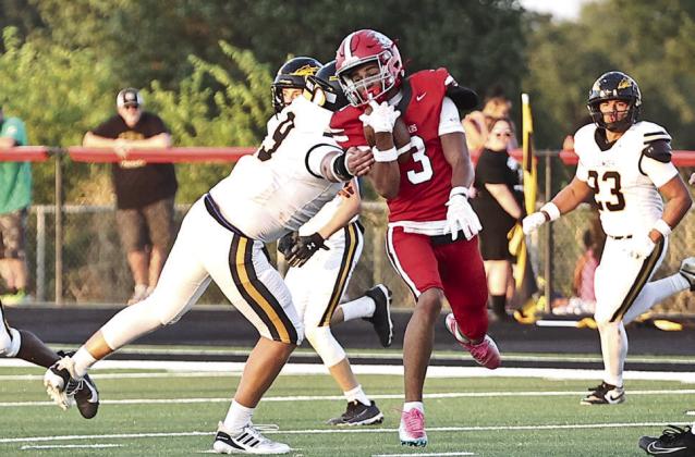 NRC's Tyson Hawkins slips the Tecumseh defender to score a touchdown.