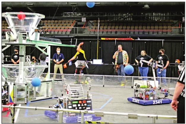 The Sprockets robot (#2341), on the Blue Alliance, shoots dodge balls toward a cone during a quarterfinal round of the Oklahoma Regional FIRST Robotics Competition at FireLake Arena on March 12. David Koonce was the announcer for the event, which was held in Shawnee for the first time. Countywide &amp;amp; Sun/Natasha Dunagan