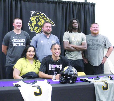 Tecumseh senior Marquan Krush signed a letter of intent to play football with Southwest College in Winfield, KS on March 14. Head Football Coach Ty Bullock and THS Principal Randy Dilbeck spoke at the event about Krush’s faith, integrity, unselfishness and work ethic. Shown, seated, is his mother Stacia Thompson and Krush, back row second from left, Bullock, with assistant coaches, Indy McNutt, far left; Josiah Wright and Easton Marrs. Countywide &amp;amp; Sun/Natasha Dunagan