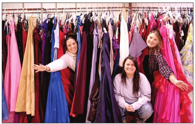 Say Yes To The Prom Dress event coordinators Jessica Hernandez, Okie Dokie Mercantile &amp;amp; Co’s Christina Hernandez, and Cassie Low hide among racks of dresses they were sorting in preparation for the event. The pop up dress closet will provide high school students with approximately 1,500 free dresses to choose from for prom, during the three day event, March 18-20. Countywide &amp;amp; Sun/Kendra Johnson