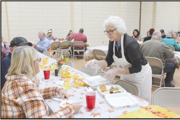 Louise Blumenthal, right, takes dessert orders from Mitchel and Kathy White of Tecumseh during the 18th Annual Tecumseh Family Thanksgiving Dinner.