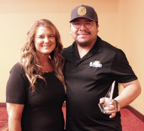 Kendra Sullivan, last year's winner and owner of The Farmer's Daughter Market, presents the Business of the Year Award to Marco Marcovilla of El Malecon. Sullivan, owner of The Farmer's Daughter Market, received the Business Person of the Year Award. Natasha Dunagan, Countywide &amp;amp; Sun