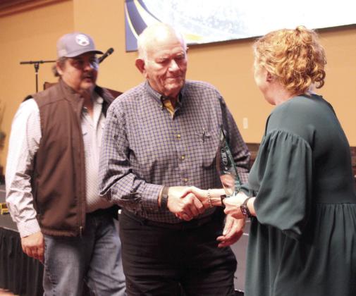 Kacy Kinsey, right, last year's winner representing AECO Sales &amp; Services, presents the Legacy Award to Jim Allman, center, and Bill Coker with 4-Way Automatic Transmissions. Natasha Dunagan, Countywide &amp; Sun
