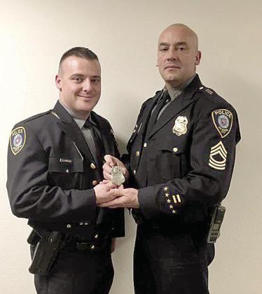 Tony Foreman and his his son Kalob Foreman pose for a photo after Kalob graduated from the Police Academy. The badge the two are holding is in memory of Dad/Grandpa, Larry Foreman also retired from the Oklahoma City Police Department. Photo provided