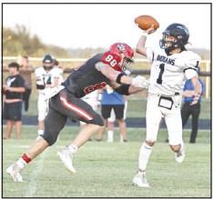 North Rock Creek’s Maddox Motley puts the presser on the Llittle Axe quarterback.