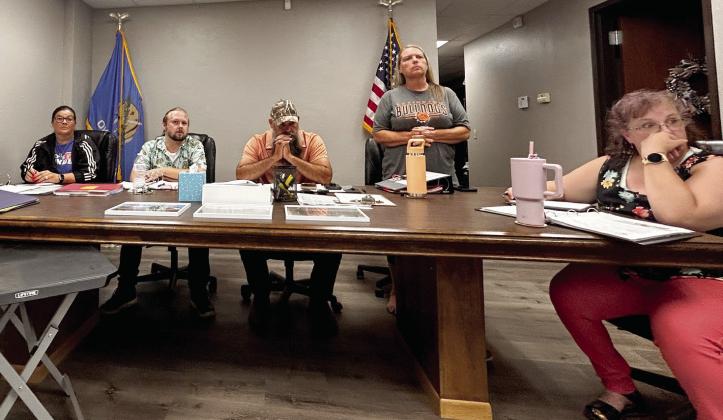 Wanette Trustee Kristina Brock (standing) closes her agenda notebook and gathers he belongings as she prepares to leave during the heated discussions early in the meeting. She did eventually sit back down and finish the meeting. However, the Wanette receptionist did leave the meeting. Pictured, from left, are trustees Jennifer Sanders, Matthew Goad, Mayor Nathan Gregory, Trustee Brock, and Clerk/Treasurer Angela Larman. Suzie Campbell, Countywide &amp; Sun