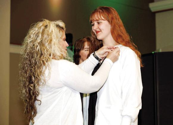 Dr. Stephanie Parker, chair of the Oklahoma Baptist University School of Nursing, is shown with graduating nursing student Audrey Branham during the Pinning and Lamp Lighting Ceremony on Friday at Immanuel Baptist Church in Shawnee. Photo provided