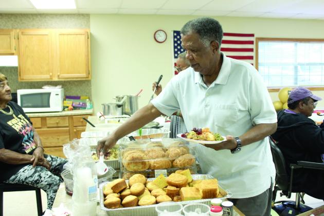 Bobby Jackson, who was originally from Brooksville and now lives in Midwest City, serves himself during the Brooksville 122nd Anniversary Celebration, held at the Brooksville Community Center on Oct. 18. Brooksville is one of the remaining 13 all-black towns in Oklahoma, out of an original 50-plus, according to the Oklahoma Historical Society website. It was originally named Sewell, but was renamed in 1912 after A.R. Brooks, a cotton buyer and farmer. Full cutline below. Natasha Dunagan, Countywide &amp; Sun