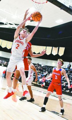 Pictured left, North Rock Creek’s Kohen Warden (2) grabs a rebound away from Chandler’s Zalen Smith during the second half of the Cougars’ win over Chandler in the finals of the Okemah Tournament.