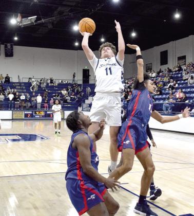 Carter Whipkey sinks two to take the lead in the Feb. 14 game against Nathan Hale. The Wolves won a hard fought battle 48-42. Countywide &amp; Sun/Julie Talton