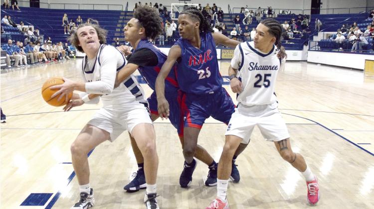 Toby Gray fights for the shot while Isaiah Smith steps in to help during the last regular season game on Feb. 14 against Nathan Hale. The Wolves pulled off the win 48-42. Countywide &amp; Sun/Julie Talton