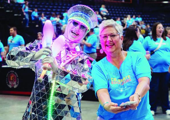 The “Mirror Man” poses with an area teacher before the event begins. Photo by Jesse Monday Media
