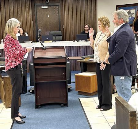 Shawnee City Clerk Lisa Lasyone (left), swears in the new Ward 2 City Commissioner Greta Madson, and new Mayor Eric Stephens. With the recent change to the charter, newly elected officials take office the first meeting after winning an election. Both were also presented with their Certificate of Election. Photo provided by the City of Shawnee