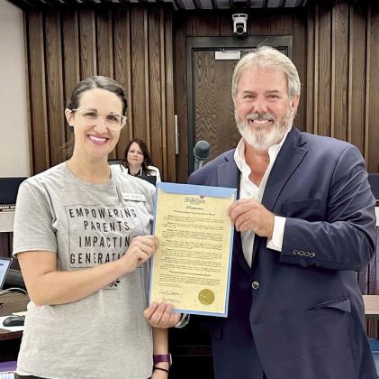 Lacey Holt, Executive Director at Legacy Parenting Center receives a Mayor’s Proclamation designating Sept 23-29, 2024 as National Diaper Awareness Week. Photo provided by the City of Shawnee
