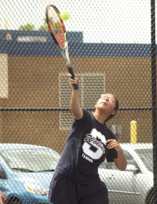 Shawnee senior Isabela Garza serves during the Suburban Conference Tournament on April 13. Garza is on the #1 Doubles team with sophomore Madalyn Rosenquist, and they placed second.