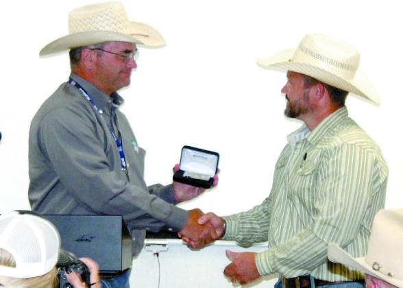 IPRA/IFYR General Manager Dale Yerigan presents a Montana Silversmith credit card holder to Dr. Alex Simpson who has served as the veterinarian on-call at the IFYR for 10 years. Natasha Dunagan, Countywide &amp; Sun