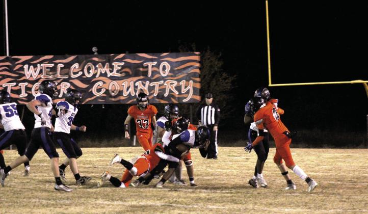 A few Maud defensive players take down a Coyle ball-carrier in the second quarter of the Class C OSSAA First-Round Playoffs on Nov. 10. The Tigers lost a hard-fought home game to the Coyle Blue Jackets, 14-60. They end the season with a record of 7-4. Countywide &amp; Sun/ Natasha Dunagan