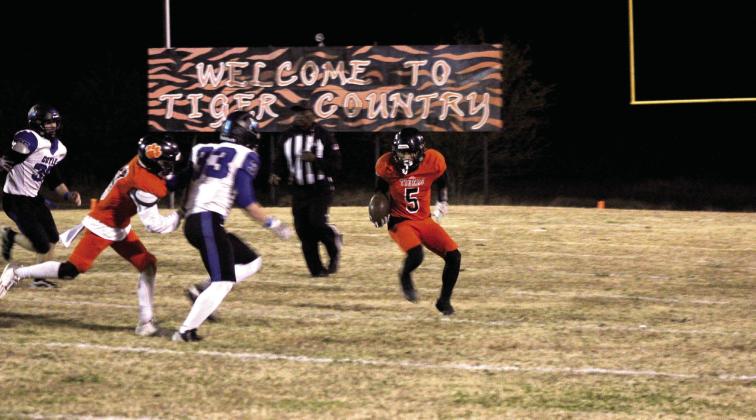 Maud junior Curtis Jordan evades the Coyle defense as he carries the ball for a third down and five yards in the second quarter of the Class C OSSAA First-Round Playoffs.