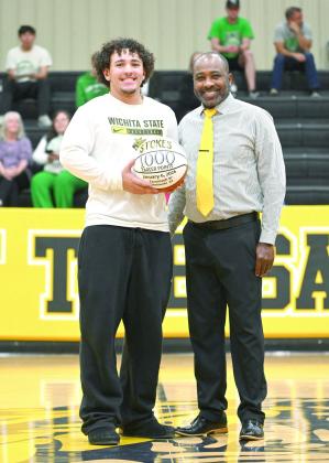 Tecumseh senior Aveon Stokes receives a game ball from Head Coach Bryant Edwards at halftime of the Lady Savages home game on Jan. 13. The ball was in honor of Stokes reaching 1,000 career points during the home game against Seminole on Jan. 6. Photo courtesy of Kenetta Lisenbee