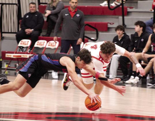 Dale senior Wyatt Seeley and an Oklahoma Christian School (OCS) player scramble for the ball during the Dec. 13 game.