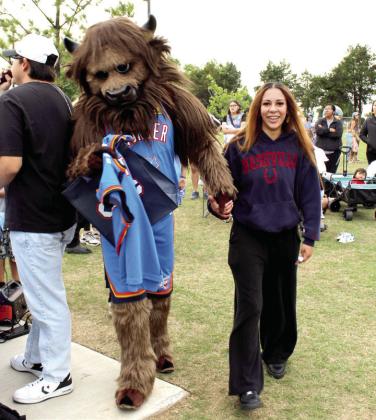 Lillie Thornton of Shawnee is escorted by Rumble the Bison to have their picture taken after she won a drawing for a signed Lou Dort jersey during the Thunder UP Tour at KidSpace Park on April 30. Natasha Dunagan, Countywide &amp;amp; Sun