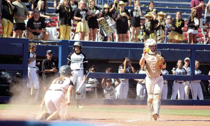 Tecumseh catcher Jessi Hull holds up the ball to show that a Lone Grove runner was out in the sixth inning of the Class 4A State Fastpitch Championship.