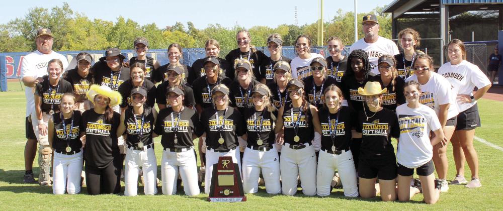 The Tecumseh Lady Savages Fastpitch Team and their coaches, Perry Wilson and Chad Trahan, pose with the Class 4A State Runner-Up Trophy following their game against Lone Grove on Oct. 15. The Lady Savages lost in the Finals, 0-3, after winning in extra innings during both the Quarterfinals with Cache, 2-1, and the Semifinals with Miami, 3-0. They end the season with a record of 29-13.