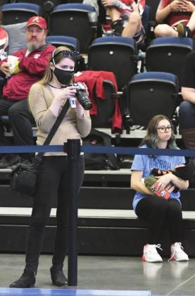 Countywide &amp; Sun journalist Kendra Johnson photographs wrestlers at the Mid-Western Conference at FireLake Arena on Jan. 28. Photo provided by Brian Blansett.