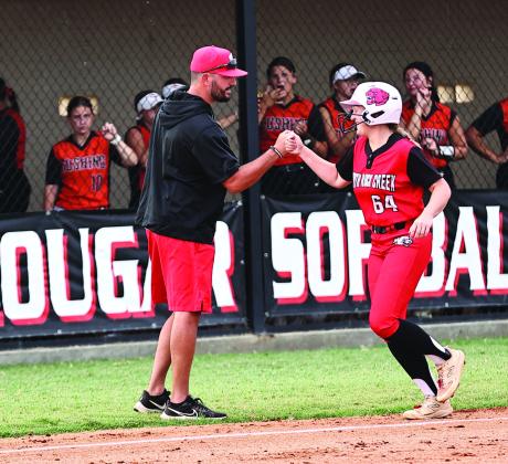 Pictured right, North Rock Creek’s Ashlyn Bade celebrates with Coach Griffin after she hits a homerun. Photo courtesy of Gowin Photography