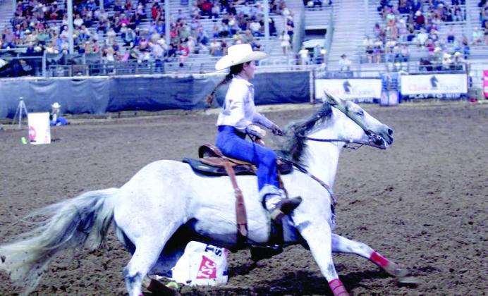 Brenna Beauchamp of Wanette rounds the third barrel in the barrel racing event of the International Finals Youth Rodeo (IFYR) on July 12.