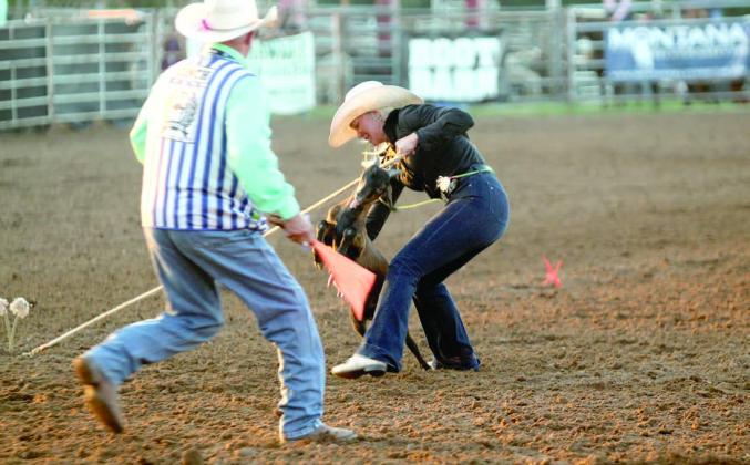 Rianne Tinsley of Shawnee works on tying her goat in the International Finals Youth Rodeo on the evening of July 13.