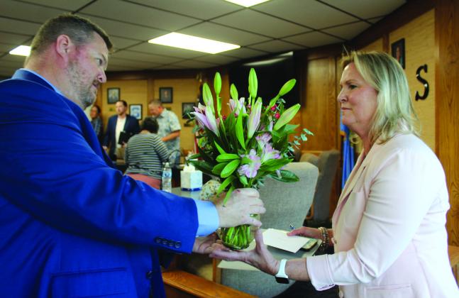 New Shawnee Superintendent Dr. Jason James presents flowers to Interim Superintendent Dr. Teresa Wilkerson following the May 5 Board of Education meeting. James said they were "mistakenly delivered to his office." Wilkerson is retiring this year. Natasha Dunagan, Countywide &amp; Sun