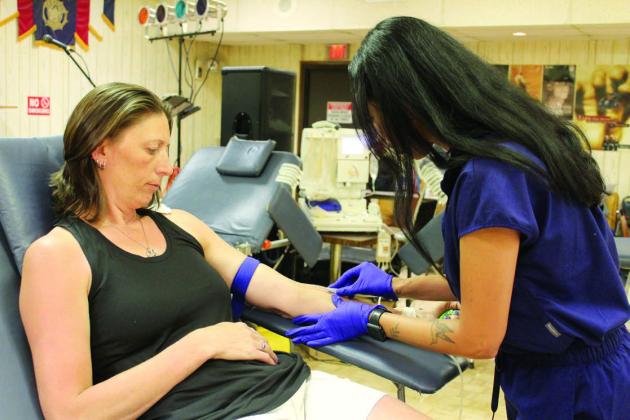 Lisa Raine of Tecumseh was one of nine people to donate blood at the Tecumseh Chamber of Commerce Blood Drive, held at the American Legion Post #260 on June 24. Also shown is Oklahoma Blood Institute Phlebotomist Amanda Mayoral. Countywide &amp; Sun/Natasha Dunagan