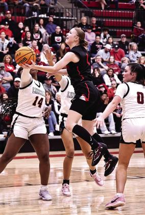 North Rock Creek's Addisen Lawrence drives between three Lincoln Christian defenders. NRC ladies tip off tonight at 6 in Hennessey. Photo courtesy of Gowin Photography