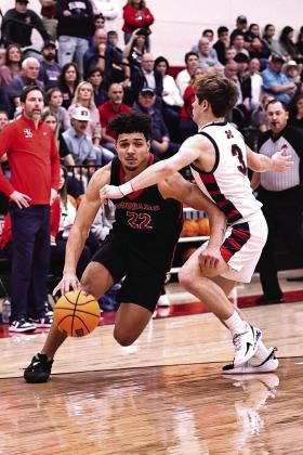 North Rock Creek's Caleb Hawkins drives to the bucket. The Cougars will travel to Hennessey to begin play in the Area tournament Mar. 7 at 7:30. Photo courtesy of Gowin Photography
