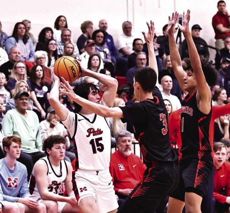 North Rock Creek's Memphis Burdine and Cason Coomer put the pressure on the Metro Christian player. NRC won 76-64, advancing to Area play. Photo courtesy of Gowin Photography