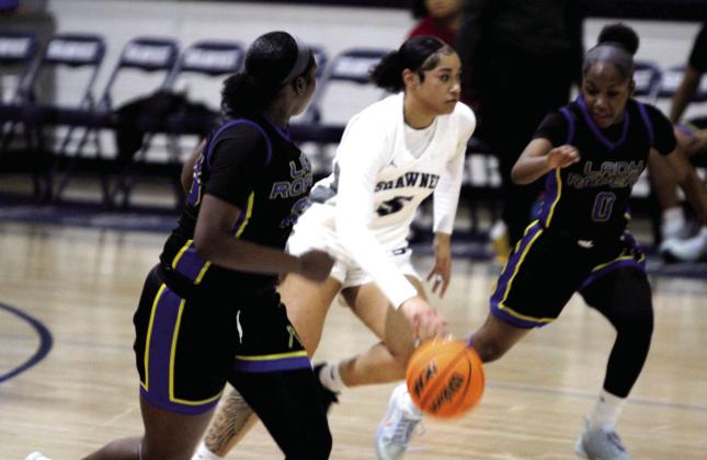 Shawnee junior Chrishelle Milum guards the ball on her way to the hoop during the Jan. 6 home game against Will Rogers. The Lady Wolves won 46-26, and the Wolves followed suit, 82-25. Natasha Dunagan, Countywide &amp; Sun