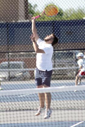 Shawnee junior Bryce Comstock, on #1 Doubles with junior Benji Cole, serves during the Shawnee NGB (National Governing Body) Tournament on May 3. They were playing against Tecumseh. Photos by Natasha Dunagan, Countywide &amp; Sun