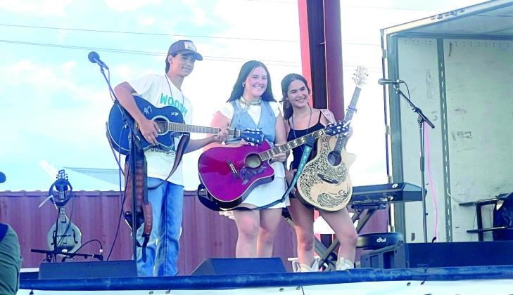 Daniel Bowlan, with Alana Chirinos and Grace Pollard at WoodyFest 2026. The trio got together and co-wrote their song in just a few hours, then performed it on stage. Photo Provided