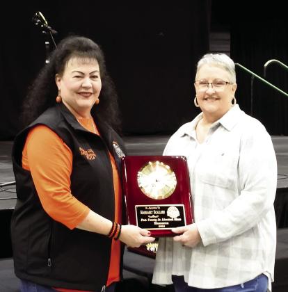 Margaret Scallorn and Shawn Fleming were honored as volunteers for the Pottawatomie County Junior Livestock Show. Each was presented a clock plaque by Suzanne Gilbert during the 34th Annual PCJLS Pig Roast and Trophy Auction on Feb. 3. Countywide &amp; Sun/Suzie Campbell