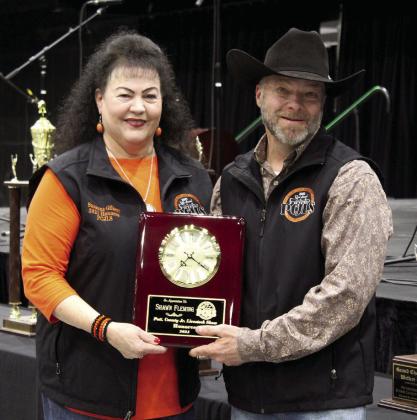 Margaret Scallorn and Shawn Fleming were honored as volunteers for the Pottawatomie County Junior Livestock Show. Each was presented a clock plaque by Suzanne Gilbert during the 34th Annual PCJLS Pig Roast and Trophy Auction on Feb. 3. Countywide &amp; Sun/Natasha Dunagan