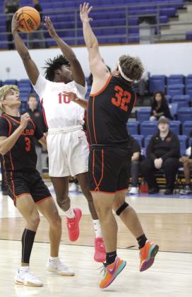 McLoud senior Shaun Hill makes a backwards jump pass to junior Castin Schafer, who then made a basket in the Bethel First United Tournament game with Sallisaw.