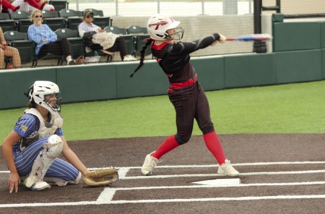 McLoud junior Miley Hicklin gets a hit, as Bethel freshman, catcher Rylee Johnson looks on, during the April 17 game. Natasha Dunagan, Countywide &amp; Sun