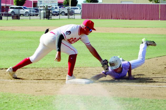 Dale senior A.J. Carpenter tries to tag an Okarche runner as he dives back to first base during the Dale Baseball Invitational Championship game on Aug. 16. Dale won their first two games - 4-1 with Preston on Aug. 14 and 6-3 with Calumet on Aug. 15 - and lost this final game, 1-6.