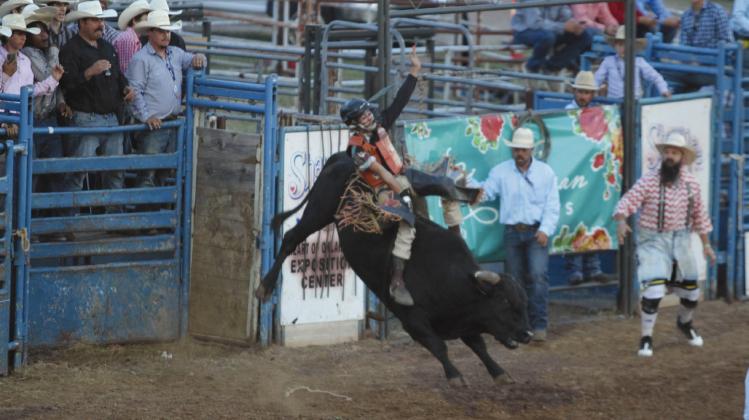 Lundan Seidl of Shawnee tries to keep his form during the International Finals Youth Rodeo opening night on July 6. Seidl has been riding bulls, like his father used to, for about a year now. Natasha Dunagan, Countywide &amp; Sun